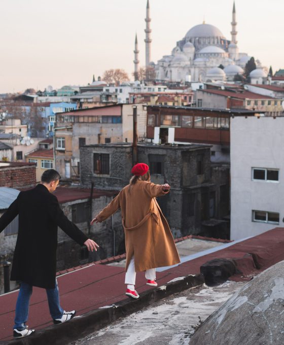 Een stel loopt op het dak van de Grand Bazaar in Istanbul met uitzicht op de Süleymaniye-moskee.